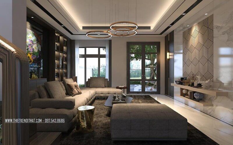 Phòng khách biệt thự đầy ấm cúng với tâm điểm là bộ sofa hiện đại kiểu dáng góc tối ưu diện tích được bọc vải êm ái màu xám tinh tế.